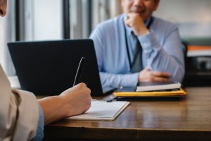 a person filling out a form at an appointment