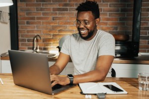 man smiling while on the computer