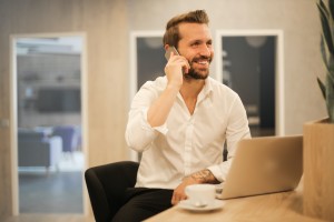 a man smiling on the phone