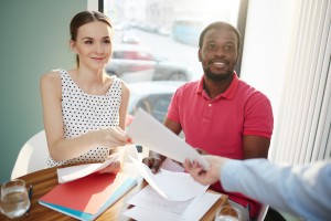 A man and a woman working with papers