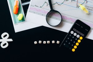 Calculator, graphs, and interests rates on desk